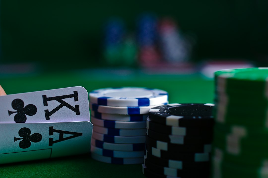 Close-up of playing cards and poker chips on a green felt table